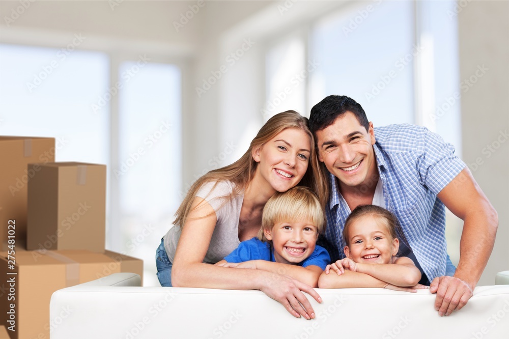 Beautiful smiling family sitting at sofa at home Beautiful smiling family sitting at sofa at home