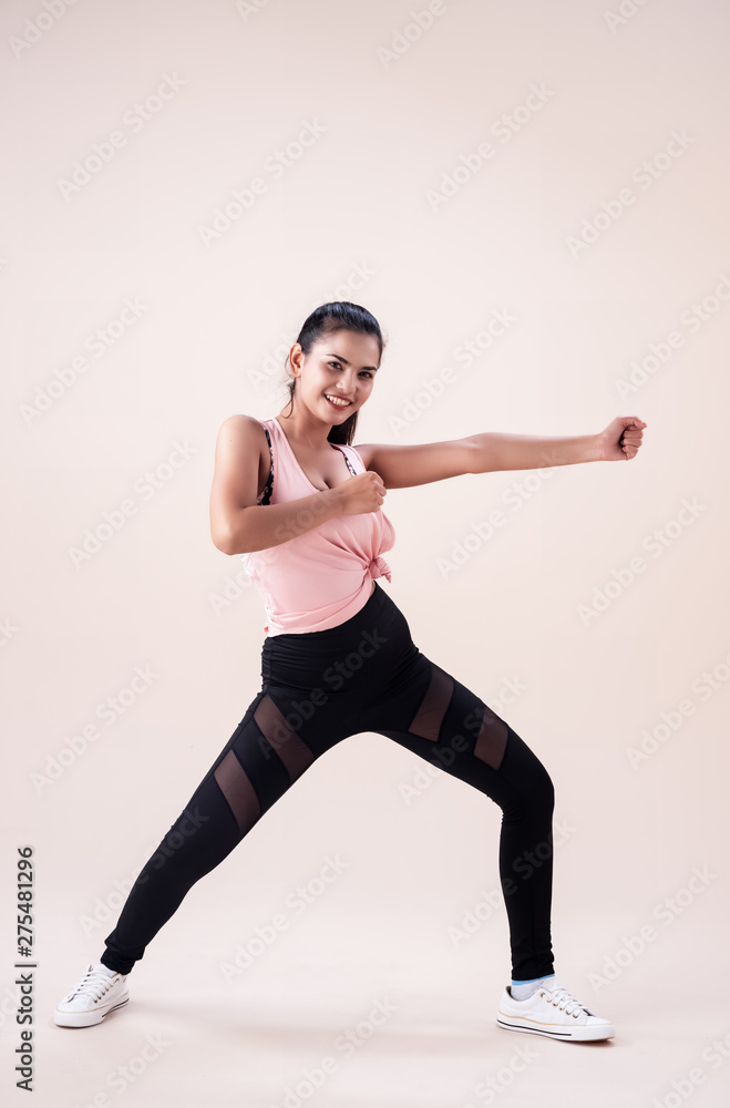The young woman wearing sportwear, posing Zumba dance workout,basic pattern,for exercise,with smile and happy feeling