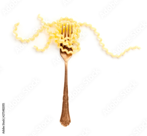 Italian pasta. An overhead photo of a vintage style fork with long fusilli on a white background with copyspace