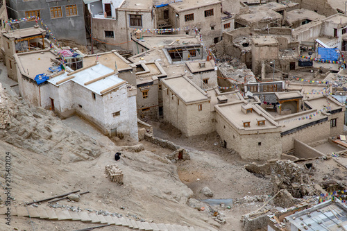 Leh Ladakh city view from Leh Palace on winter. Beautiful amazing village in the valley with snow mountain at background. Ladakh, India.