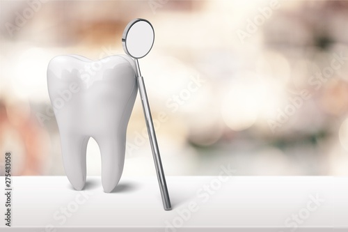 Big tooth model and toothbrush on background