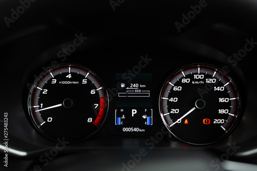 close up modern mileage car dashboard instrument panel interior with warning lights, seat belts and handbrake lights. Miles Speedometer 