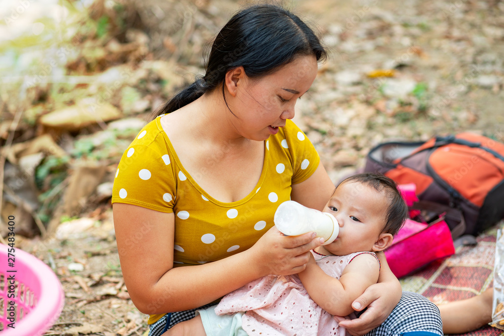 Asian cute baby girl drinking milk from bottle, Toddler sucking milk bottle Asian cute baby girl drinking milk from bottle, Toddler sucking milk bottle