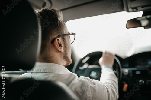 driver businessman rides a business class car through the city in sunglasses. luxury taxi services. © velimir