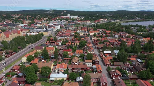 Ascending drone footage flying over the city of Falun. In the background the ski jumping area - Lugnet - is visible and on the right hand side the lake Runn is visible. Filmed in realtime at 4k. photo