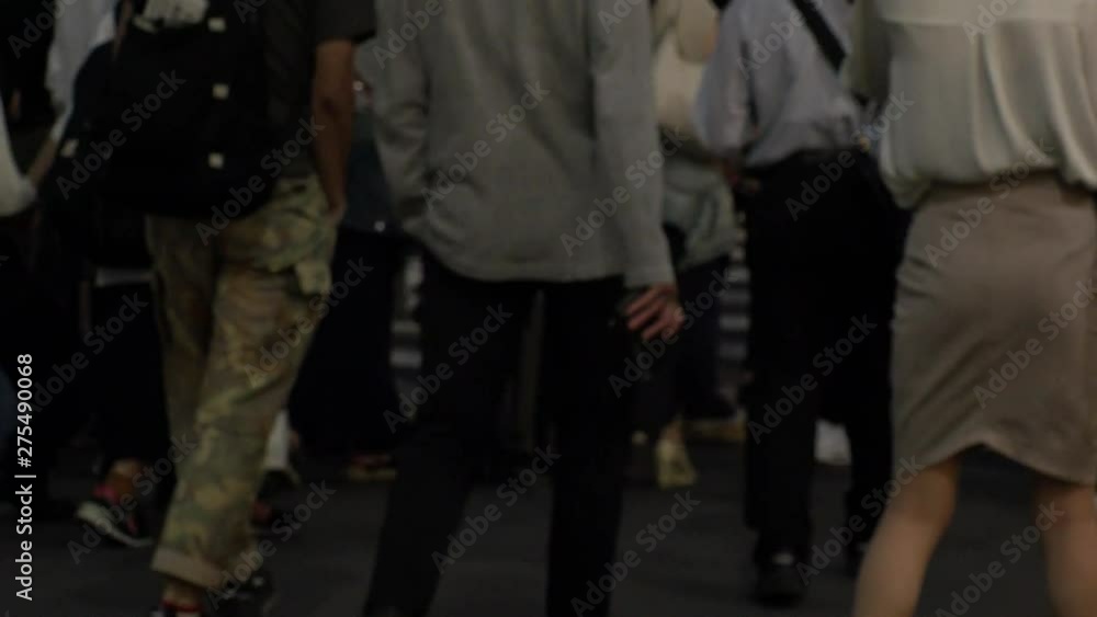 SHINJUKU, TOKYO, JAPAN - CIRCA JUNE 2019 : View of crowd of people walking down the street in busy rush hour. Many commuter walking to the train station after work. Shot in early evening. Defocus shot SHINJUKU, TOKYO, JAPAN - CIRCA JUNE 2019 : View of crowd of people walking down the street in busy rush hour. Many commuter walking to the train station after work. Shot in early evening. Defocus shot
