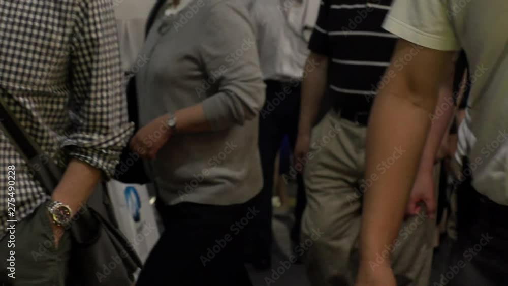 SHINJUKU, TOKYO, JAPAN - CIRCA JUNE 2019 : View of crowd of people walking down the street in busy rush hour. Many commuter walking to the train station after work. Shot in early evening. Defocus shot SHINJUKU, TOKYO, JAPAN - CIRCA JUNE 2019 : View of crowd of people walking down the street in busy rush hour. Many commuter walking to the train station after work. Shot in early evening. Defocus shot