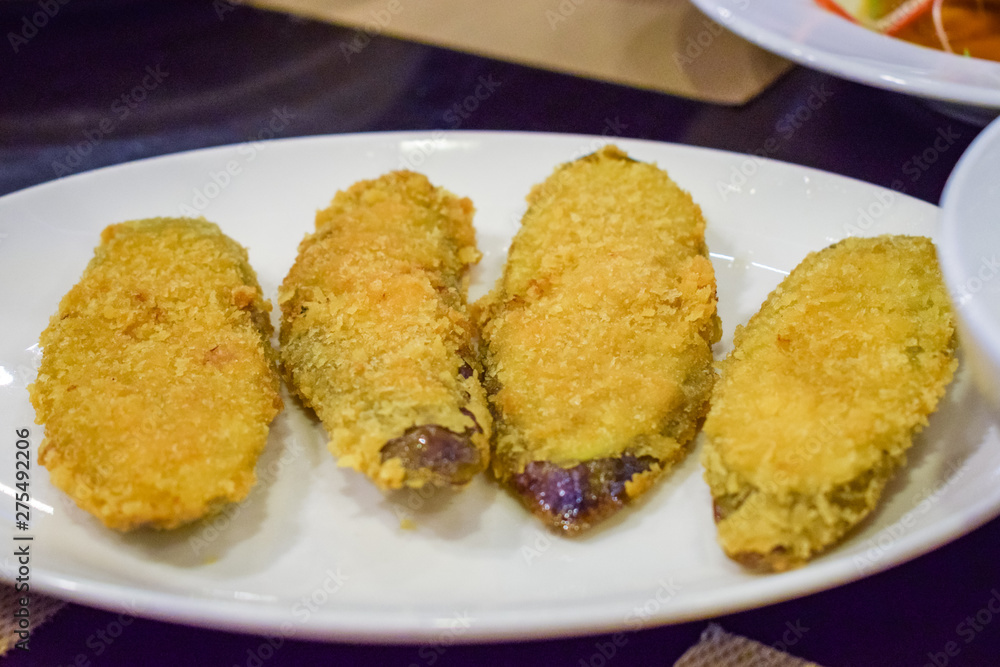 Tasty fried breaded eggplant on white plate in restaurant Tasty fried breaded eggplant on white plate in restaurant