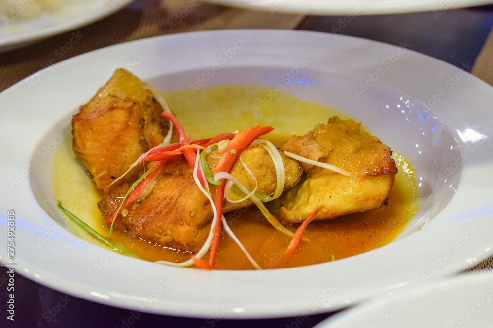Fried piece of meat with red bell pepper on whate plate Fried piece of meat with red bell pepper on whate plate
