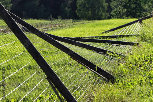 фотографія Broken metal chain fence.