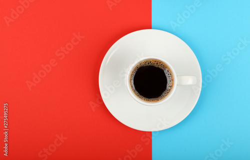 Full white espresso coffee cup on red and blue