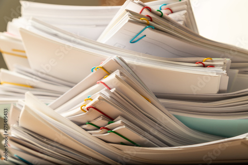 Stack of document paper with colorful paperclip.