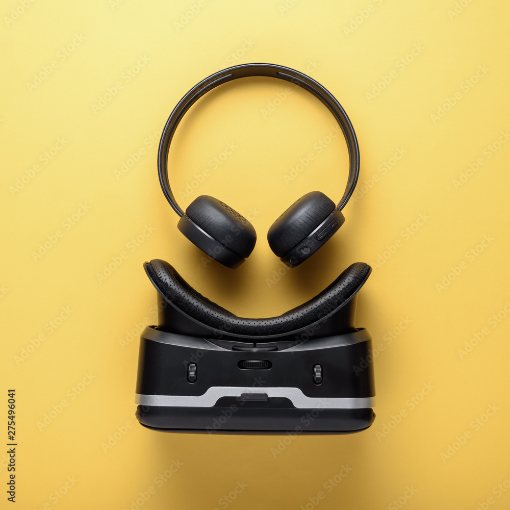 art design gadgets on yellow background, wireless headphones and VR glasses art design gadgets on yellow background, wireless headphones and VR glasses