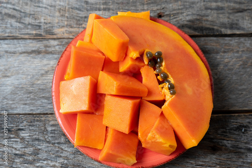 Cubes and slice of tasty papaya with seeds