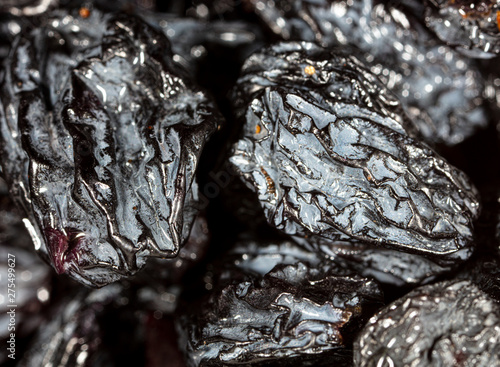 Black dry raisins as background