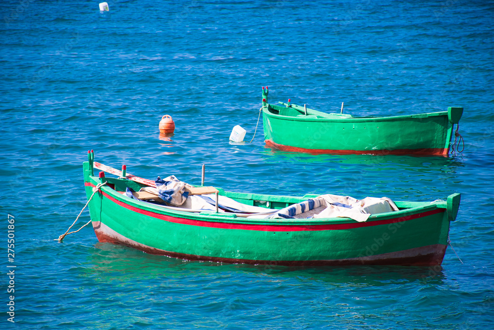 Beautiful old colored fishing wooden boats on the water