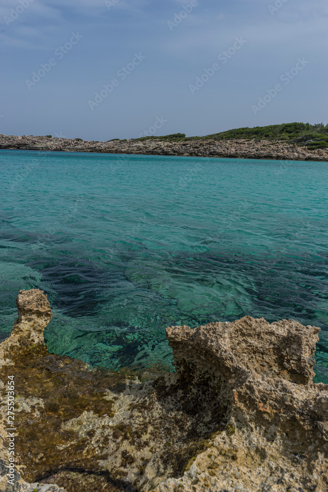 Tourism, Mediterranean sea crashing against the rocks of the Spanish island of Mallorca, Ibiza, Spain.
