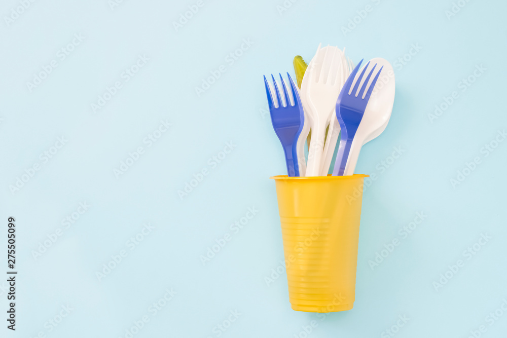 An overhead photo of plastic garbage. Plastic disposable tableware, spoon, forks in cup. Zero waste, environmental pollution. Save the planet concept, Recycling and ecology concept. Place for text. An overhead photo of plastic garbage. Plastic disposable tableware, spoon, forks in cup. Zero waste, environmental pollution. Save the planet concept, Recycling and ecology concept. Place for text.