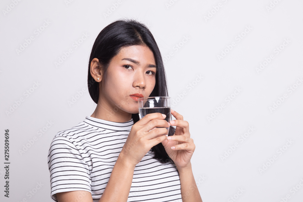 Young Asian woman with a glass of drinking water. Young Asian woman with a glass of drinking water.