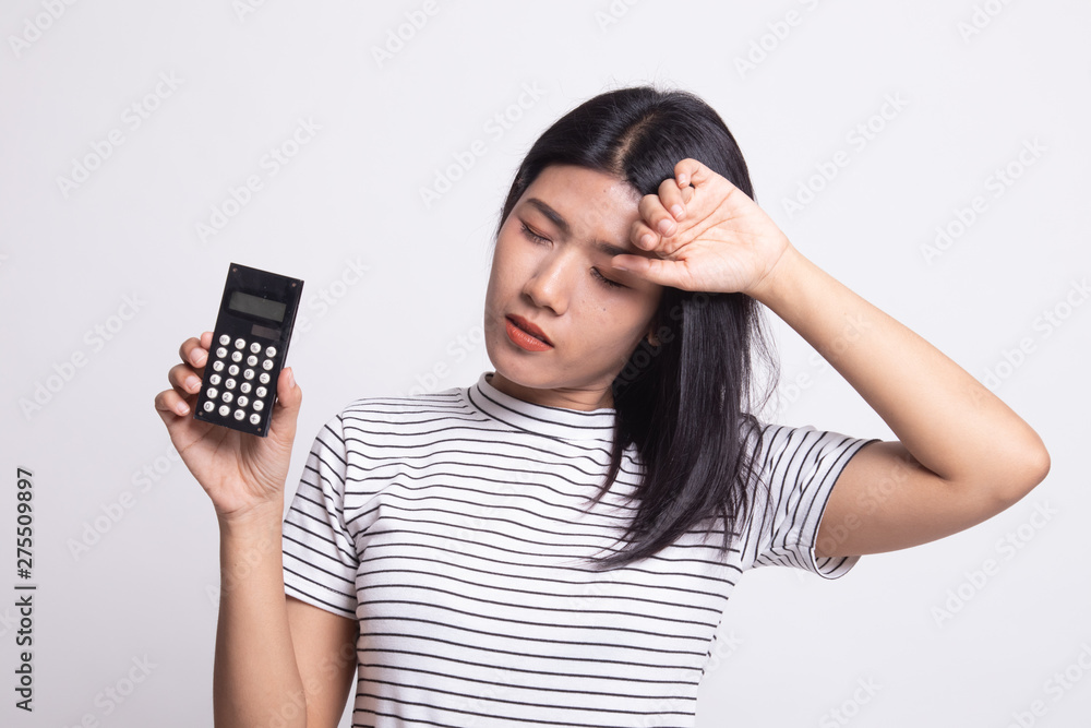Asian woman got headache with calculator. Asian woman got headache with calculator.