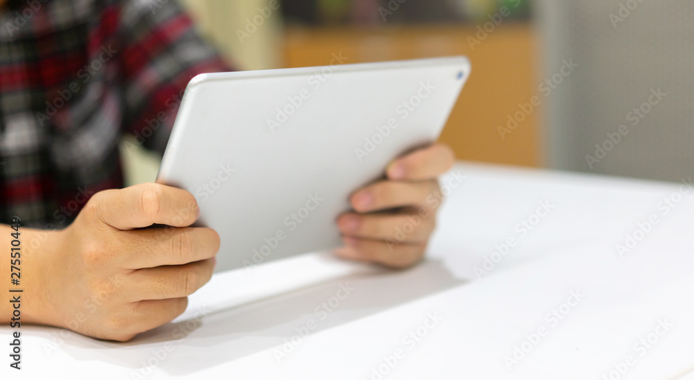close up father hand holding digital tablet and using internet connection for video call with family in living room at house for long distant communication concept close up father hand holding digital tablet and using internet connection for video call with family in living room at house for long distant communication concept