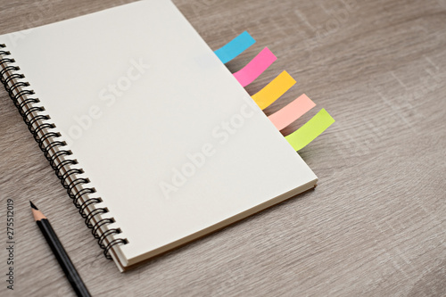 blank book and pencil on blank book on the wooden table.