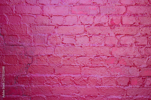 Brickwork crimson color with a reflection of sunny color. © Римма Мельникова