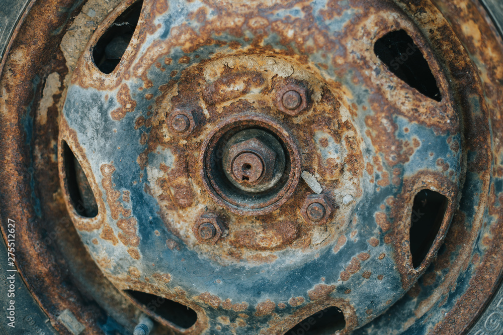 Old and weathered car wheel with damaged rusty rim – Used rubber with small cracks from vehicle tire Old and weathered car wheel with damaged rusty rim – Used rubber with small cracks from vehicle tire
