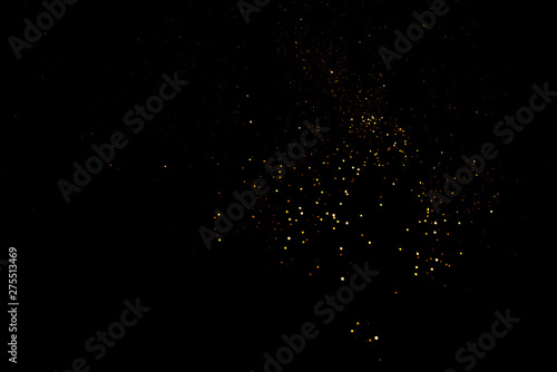 Golden abstract bokeh on black background. Holiday concept © Anna
