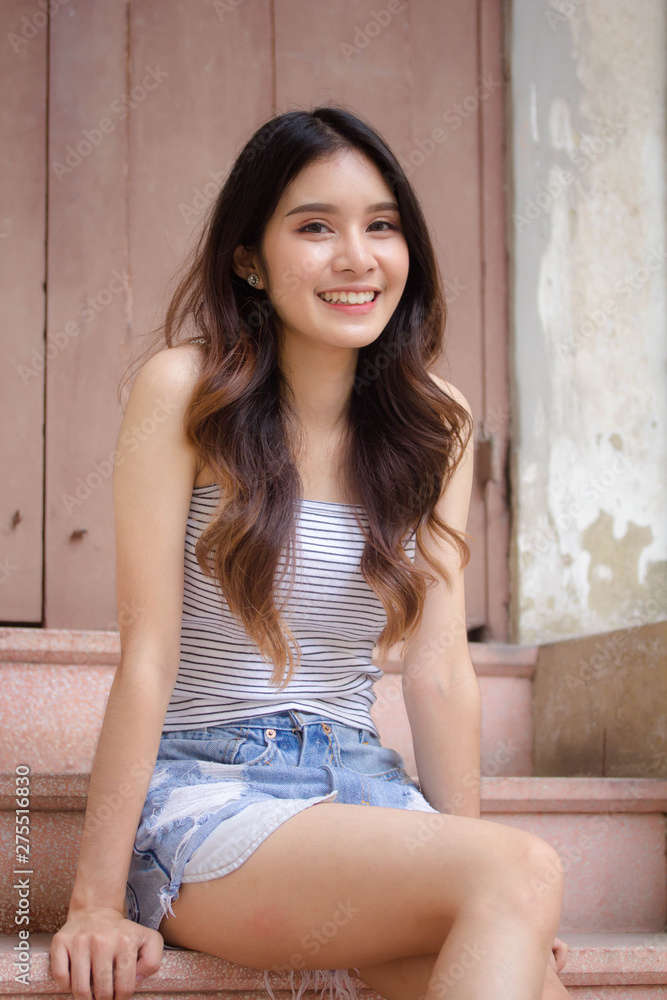 Portrait of thai adult beautiful girl White shirt blue jeans relax time Portrait of thai adult beautiful girl White shirt blue jeans relax time