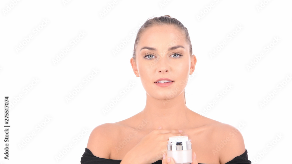 Concept of skincare. The portrait of young woman with perfect skin applying a day/night cream on her previously cleansed face. Concept of skincare. The portrait of young woman with perfect skin applying a day/night cream on her previously cleansed face.