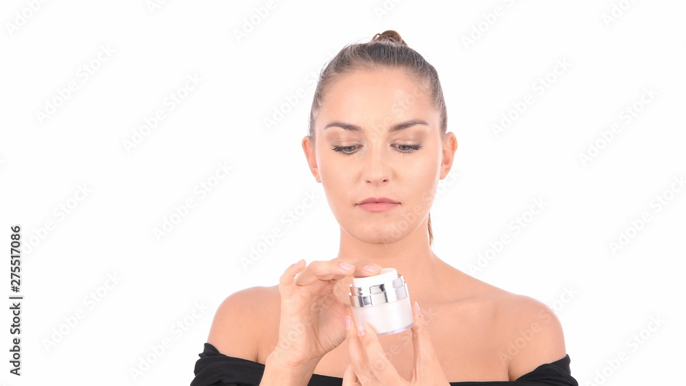 Concept of skincare. The portrait of young woman with perfect skin applying a day/night cream on her previously cleansed face. Concept of skincare. The portrait of young woman with perfect skin applying a day/night cream on her previously cleansed face.