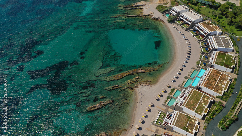 Aerial panoramic view of famous Grand Resort Lagonisi or Lagonissi paradise peninsula and beach with pool facilities in exotic peninsula, Athens riviera, Attica, Greece
