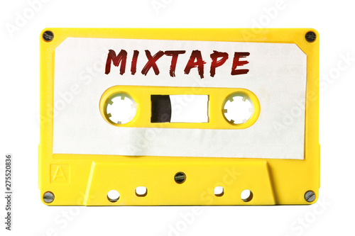 A retro vintage cassette tape (obsolete audio tech) with the handwritten text Mixtape (red marker, white label, electro yellow plastic body).