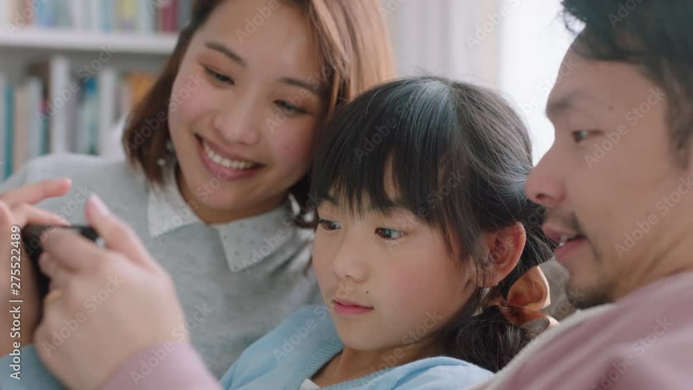 happy asian family using tablet computer little girl watching entertainment with parents playing game on touchscreen device browsing online relaxing on sofa together at home 4k footage happy asian family using tablet computer little girl watching entertainment with parents playing game on touchscreen device browsing online relaxing on sofa together at home 4k footage
