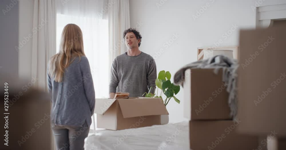 young couple moving into new house discussing home decorating ideas making decision 4k young couple moving into new house discussing home decorating ideas making decision 4k