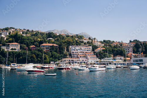 Seascape of the Adriatic Sea. The sea with mountains and mountains in the background. Boat sailing on the sea. Italy, Montenegro, Adriatic tourism