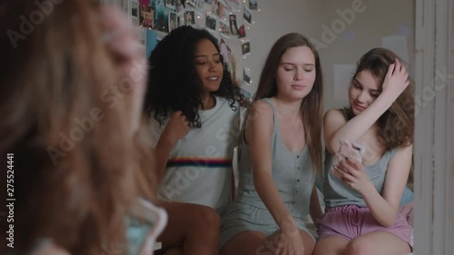 happy teenage girls taking selfie photos together using smartphone best friends posing enjoying making faces hanging out at home sharing weekend on social media