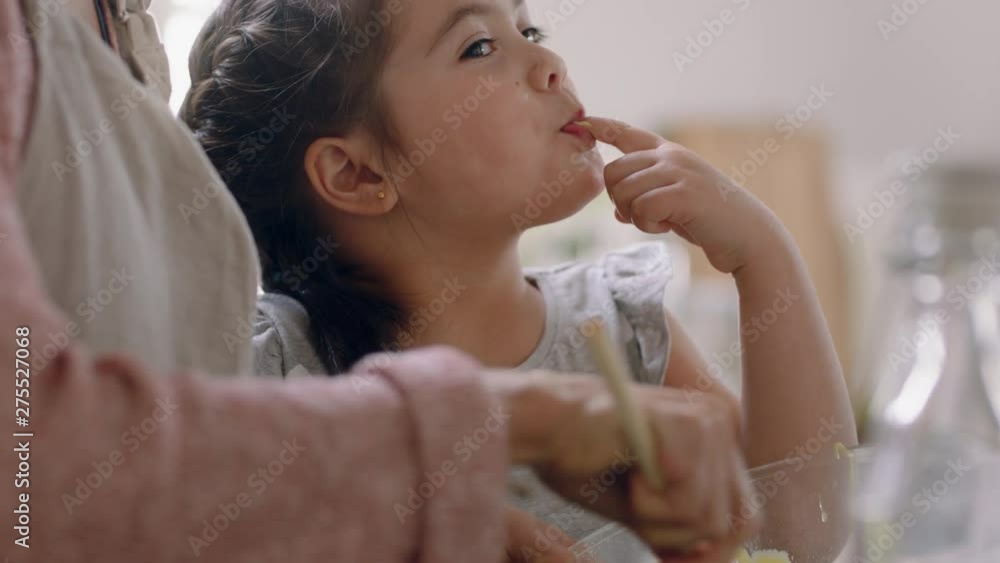 little girl helping mother bake in kitchen mixing ingredients baking cookies preparing recipe at home with mom teaching her daughter on weekend little girl helping mother bake in kitchen mixing ingredients baking cookies preparing recipe at home with mom teaching her daughter on weekend