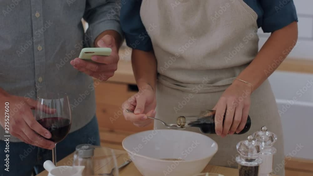 happy young couple cooking together in kitchen using smartphone browsing recipe online preparing dinner mixing ingredients enjoying healthy lifestyle making food at home 4k happy young couple cooking together in kitchen using smartphone browsing recipe online preparing dinner mixing ingredients enjoying healthy lifestyle making food at home 4k
