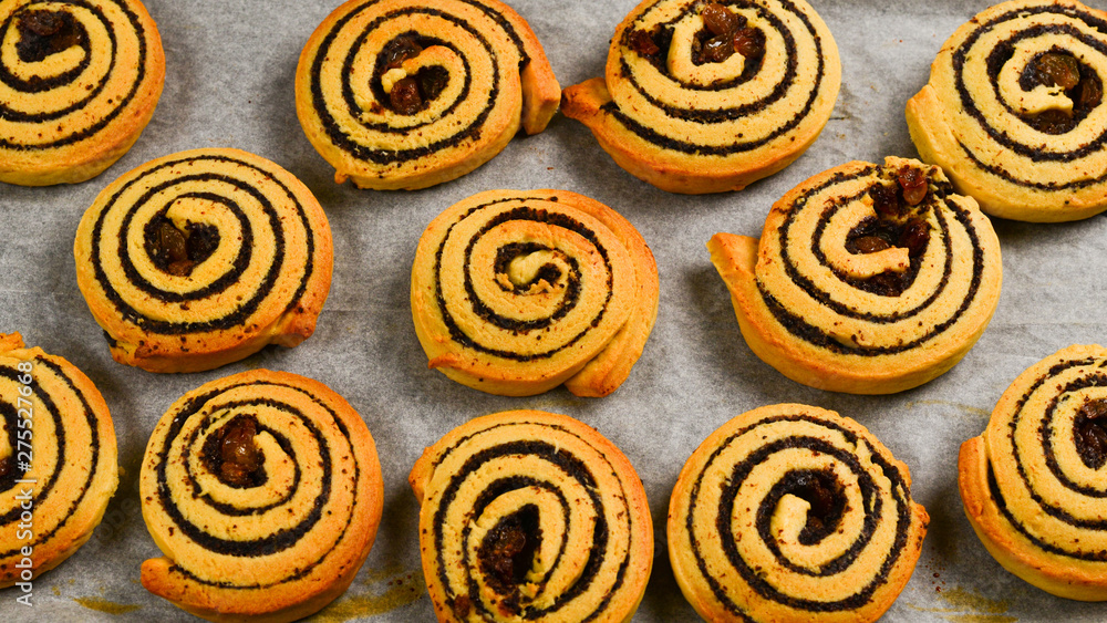 Fototapeta premium Baked cookies with raisins and poppy seeds on a trail.