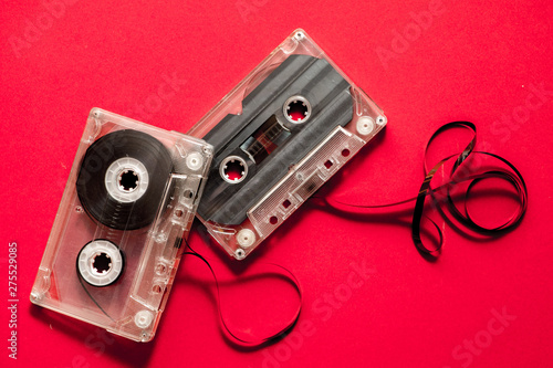 audio cassette on a red background. Old compact cassette