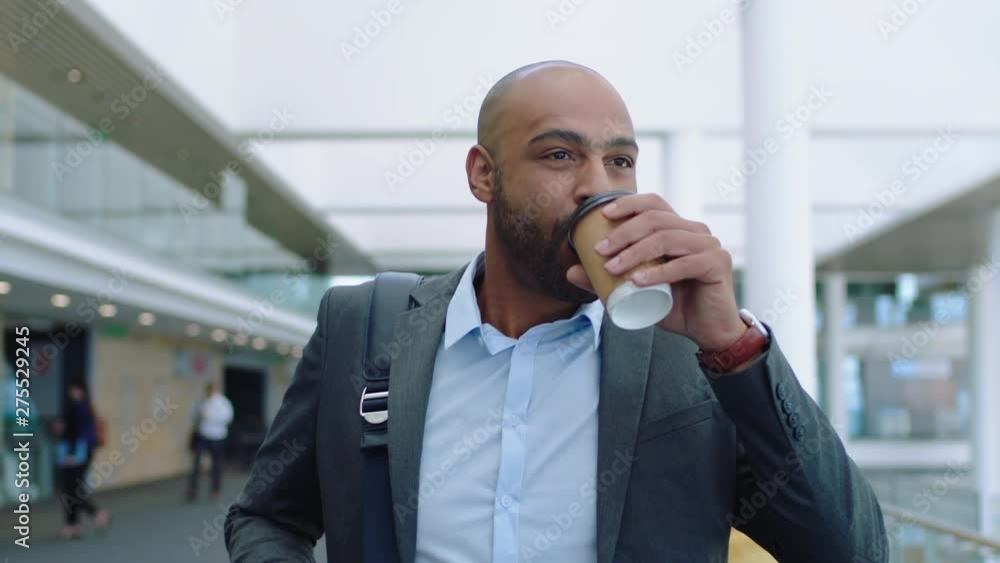 mixed race businessman walking in office lobby drinking coffee enjoying successful career looking confident male executive going to work 4k mixed race businessman walking in office lobby drinking coffee enjoying successful career looking confident male executive going to work 4k
