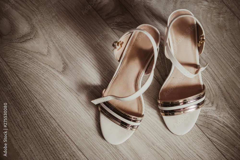 Bride shoes on wooden floor. Wedding accessories fashion background. Bride shoes on wooden floor. Wedding accessories fashion background.