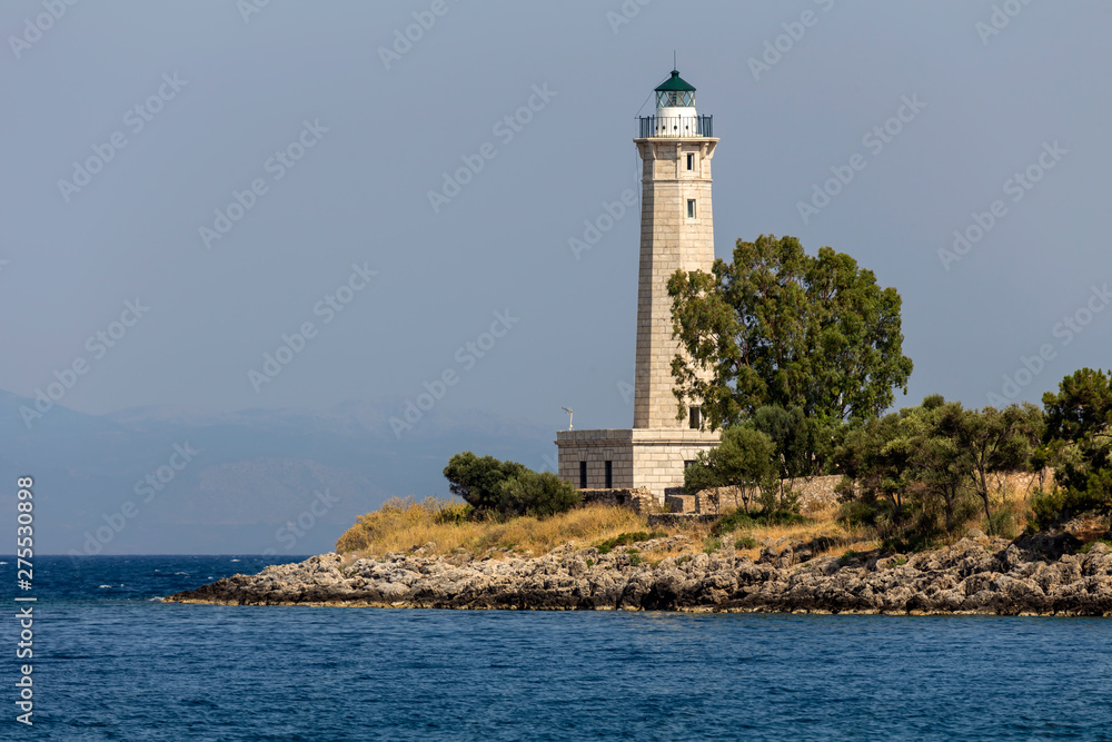 Lighthouse near the city Gythio against the background of the sea and sky (Greece, Peloponnese)