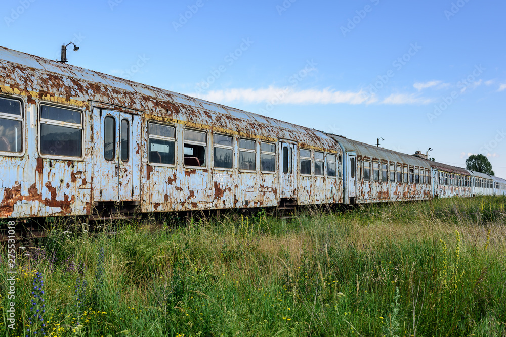 Old rusty railway wagon whit broken windows. Old abandoned track, siding with dirty old trains. Old railway tracks.