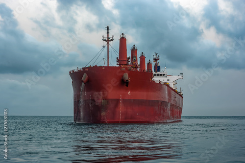 Bulk carrier vessel is awaiting loading of bauxite ore at outer anchorage of Kamsar port, Guinea, West Africa.