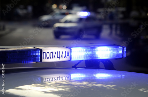 Patrol police car with blue emergency lights in traffic accident scene