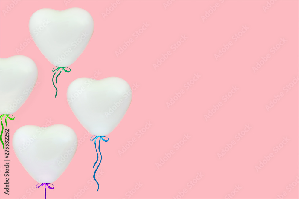 White heart shaped balloons over pastel coral pink background with copy space White heart shaped balloons over pastel coral pink background with copy space