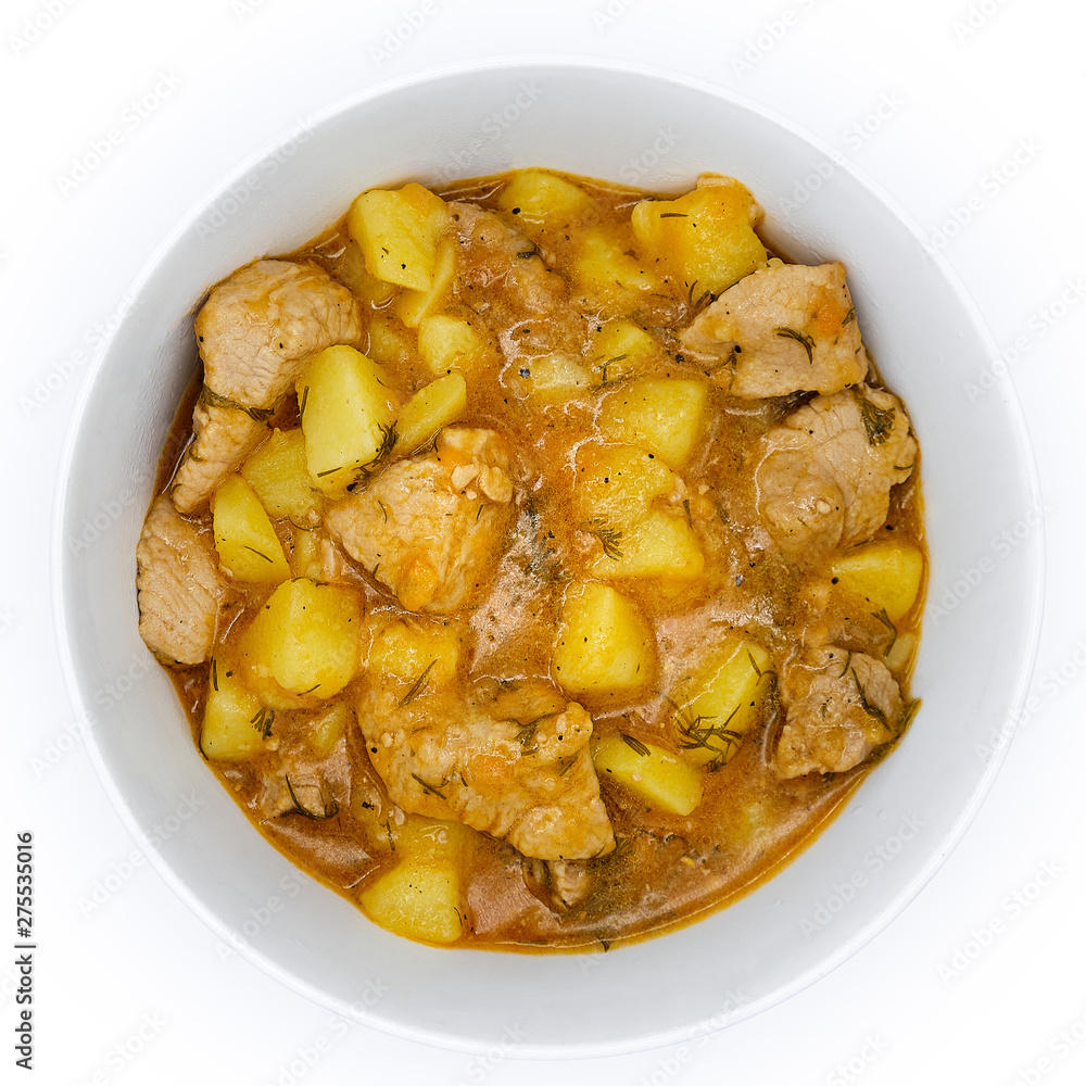 Natural food cooked at home. Ragout of tasty potatoes and owl. A plate owl of beef stewed and potatoes on isolated white background. Natural food cooked at home. Ragout of tasty potatoes and owl. A plate owl of beef stewed and potatoes on isolated white background.